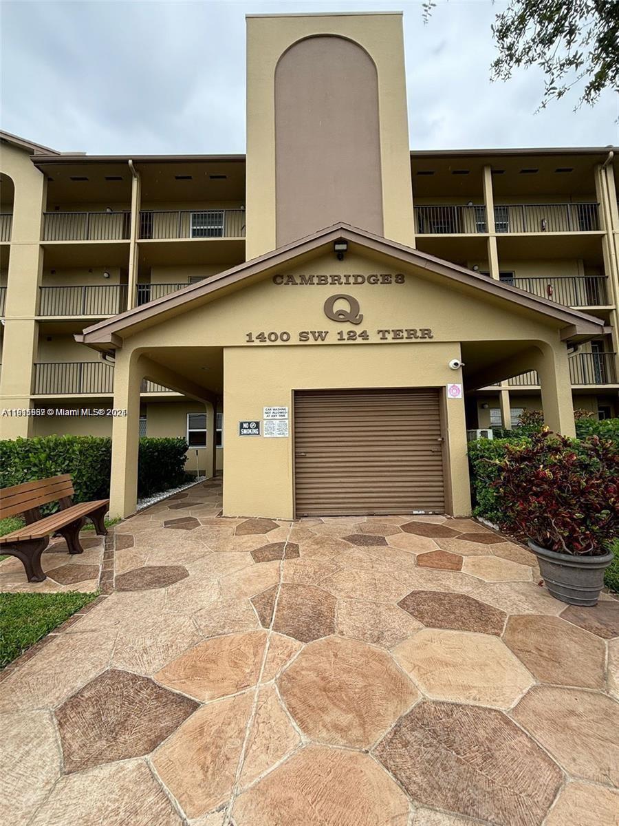 1400 Southwest 124th Terrace, Unit 402Q Pembroke Pines, FL 33027 - Photo 14 of 20 a front view of a house with a yard and garage