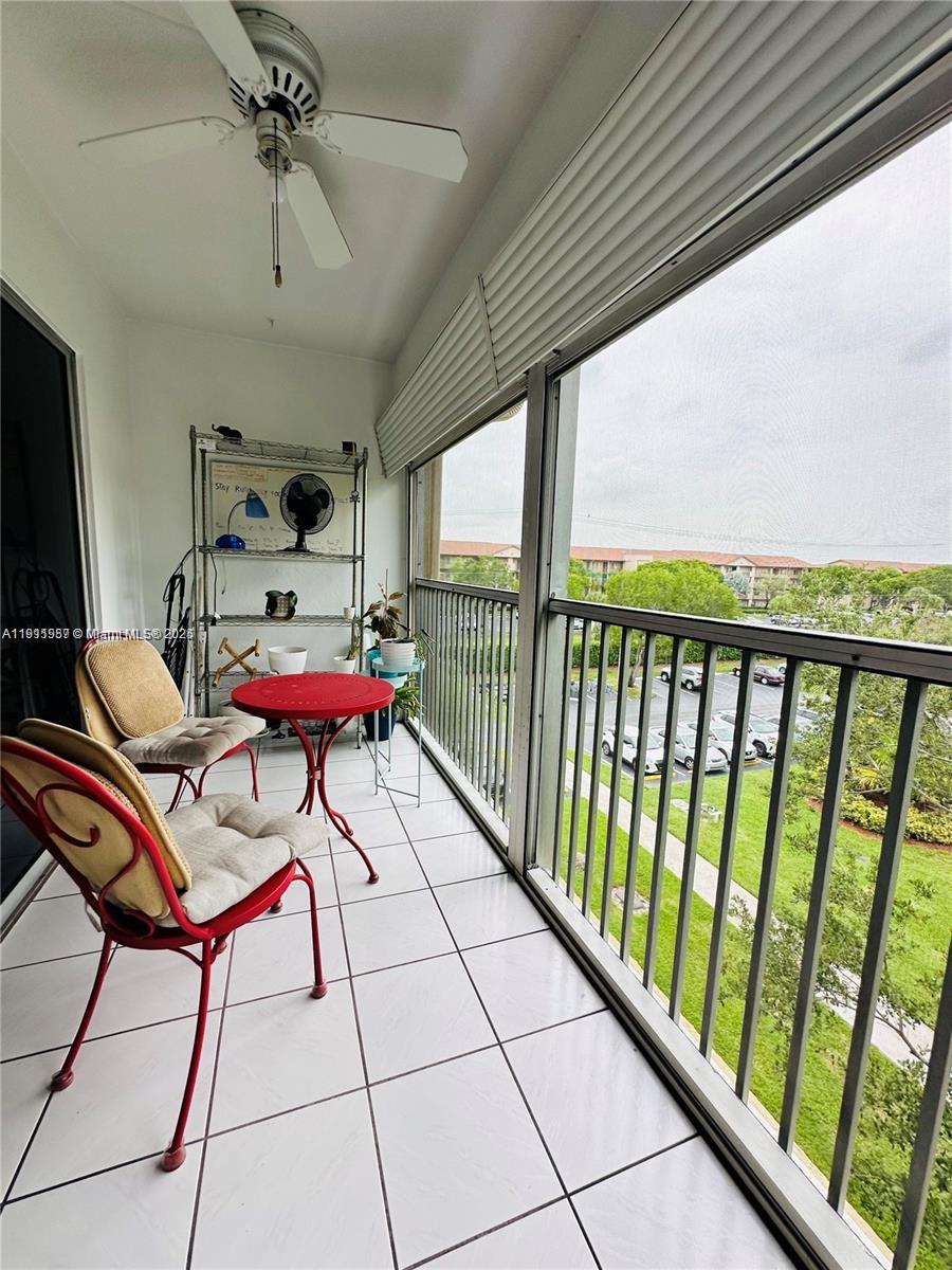 1400 Southwest 124th Terrace, Unit 402Q Pembroke Pines, FL 33027 - Photo 16 of 20 a view of a chairs in wooden deck