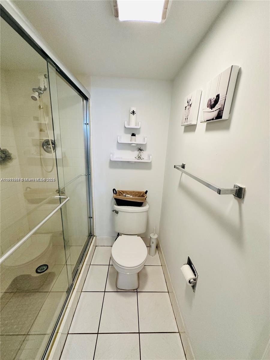 1400 Southwest 124th Terrace, Unit 402Q Pembroke Pines, FL 33027 - Photo 18 of 20 a bathroom with a toilet and a shower