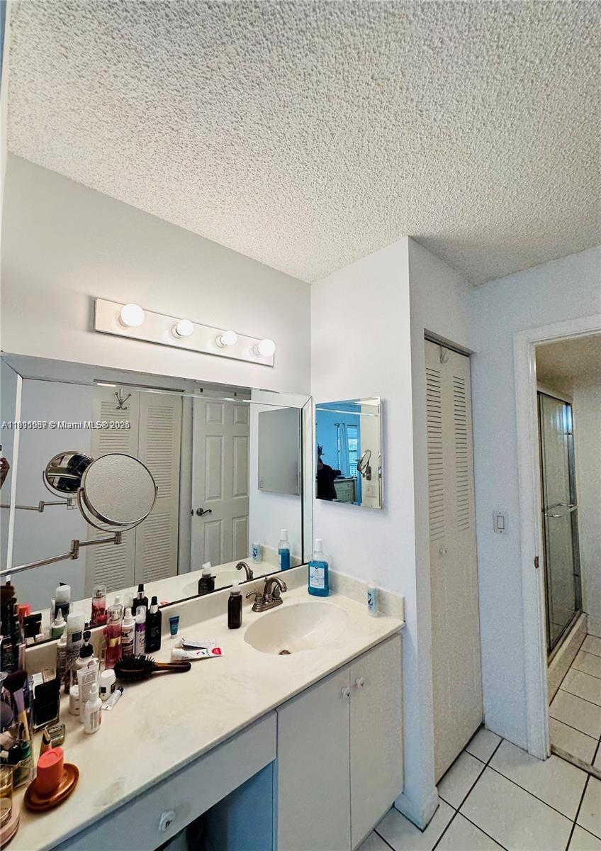 1400 Southwest 124th Terrace, Unit 402Q Pembroke Pines, FL 33027 - Photo 9 of 20 a bathroom with a double vanity sink mirror and