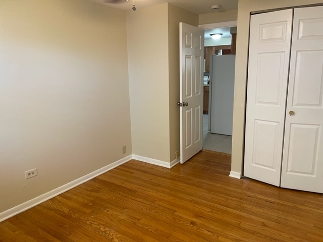 2336 Union Street, Unit 3 Blue Island, IL 60406 - Photo 13 of 19 a view of an empty room with wooden floor and a bathroom