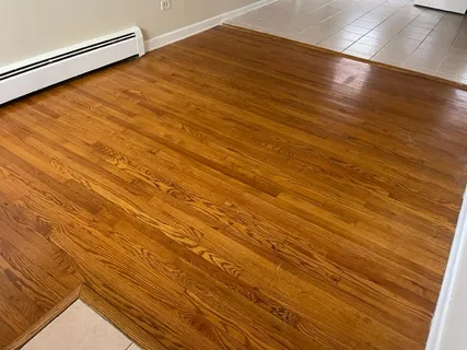a view of a room with wooden floor