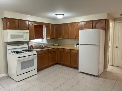 a kitchen with stainless steel appliances granite countertop a refrigerator sink and stove