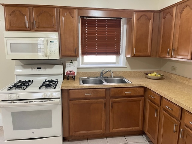 2336 Union Street, Unit 3 Blue Island, IL 60406 - Photo 7 of 19 a kitchen with stainless steel appliances granite countertop a sink stove and cabinets