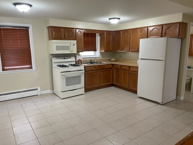 2336 Union Street, Unit 3 Blue Island, IL 60406 - Photo 10 of 19 a kitchen with stainless steel appliances granite countertop a refrigerator sink and stove