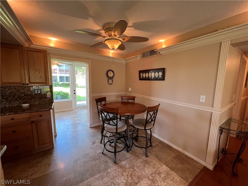 1372 Archer Street, Unit 4 Lehigh Acres, FL 33936 - Photo 11 of 22 a view of a dining room with furniture and wooden floor
