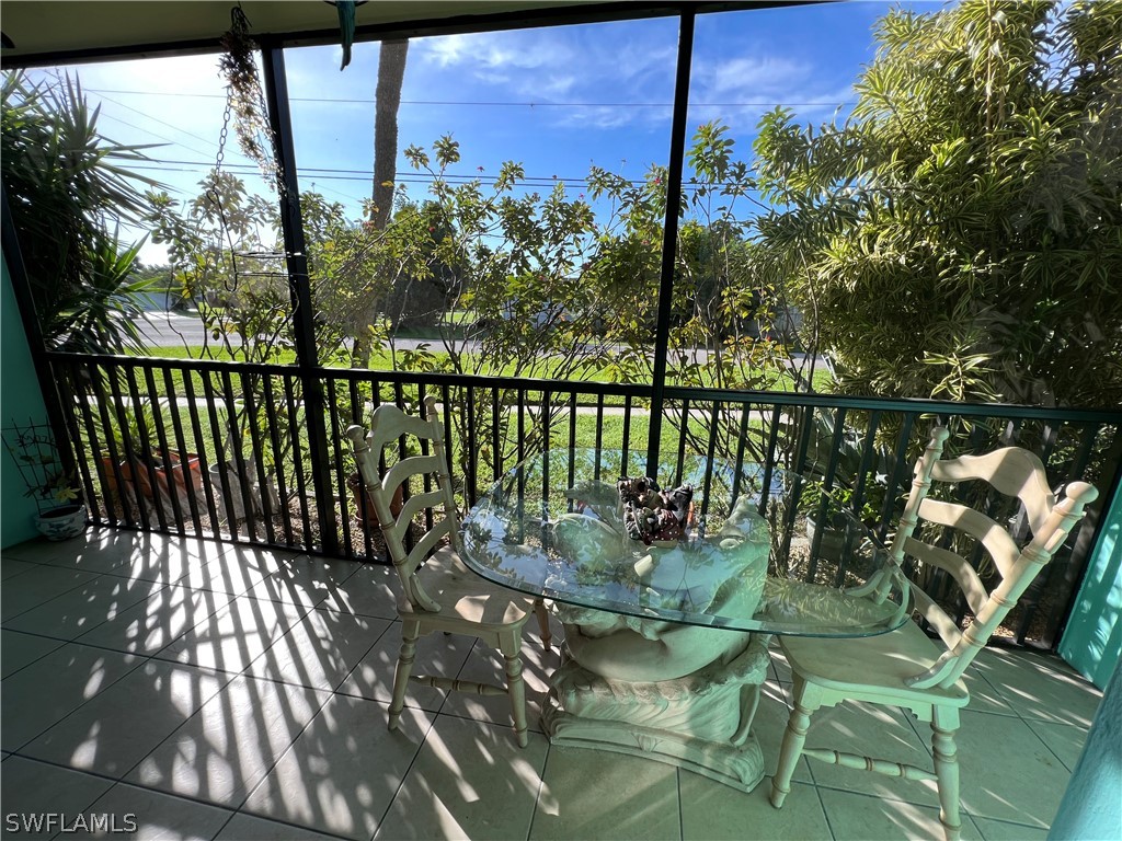 1372 Archer Street, Unit 4 Lehigh Acres, FL 33936 - Photo 16 of 22 a view of balcony with wooden floor and outdoor seating