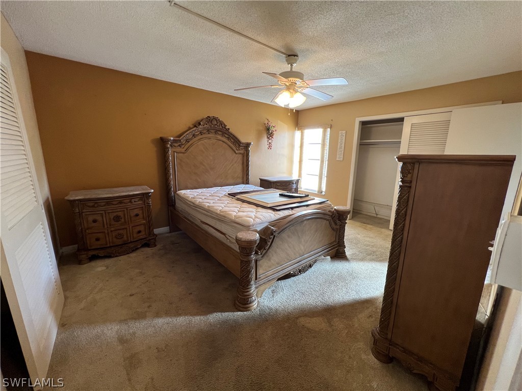 1372 Archer Street, Unit 4 Lehigh Acres, FL 33936 - Photo 19 of 22 a bedroom with a bed dresser and a window