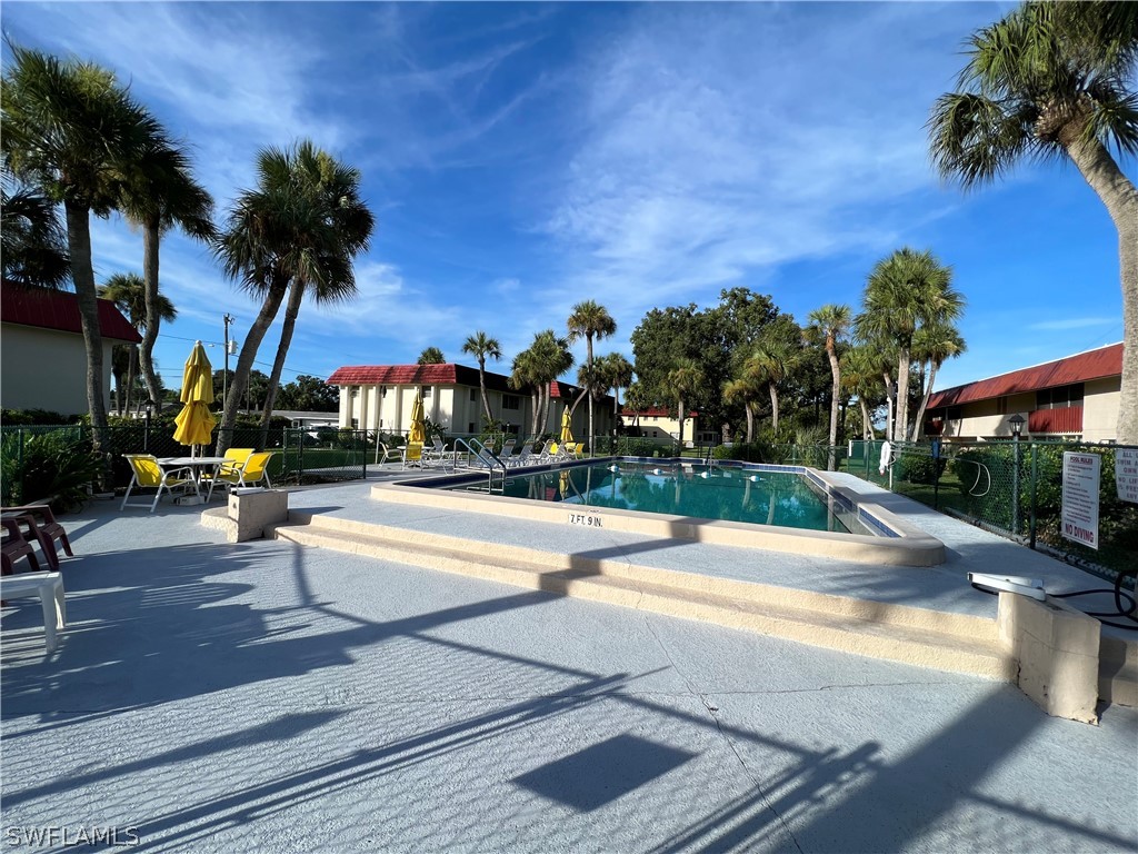 1372 Archer Street, Unit 4 Lehigh Acres, FL 33936 - Photo 3 of 22 a view of swimming pool with palm trees