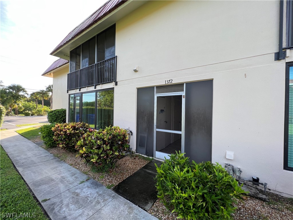 1372 Archer Street, Unit 4 Lehigh Acres, FL 33936 - Photo 6 of 22 a view of a house with backyard and garden