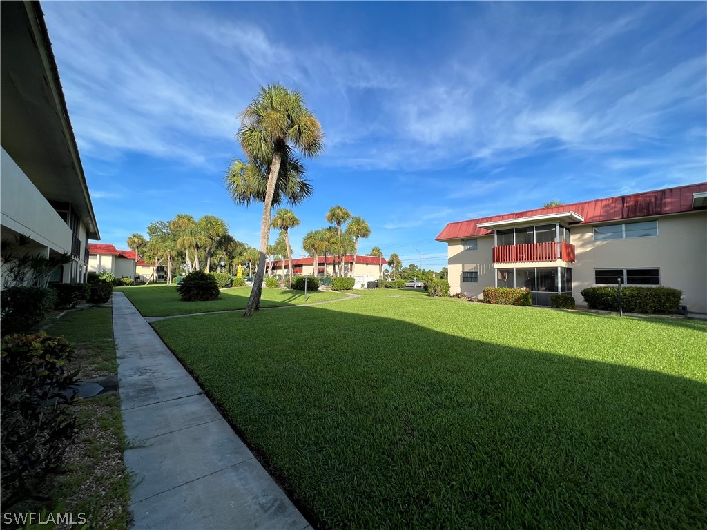 1372 Archer Street, Unit 4 Lehigh Acres, FL 33936 - Photo 7 of 22 a front view of a house with garden