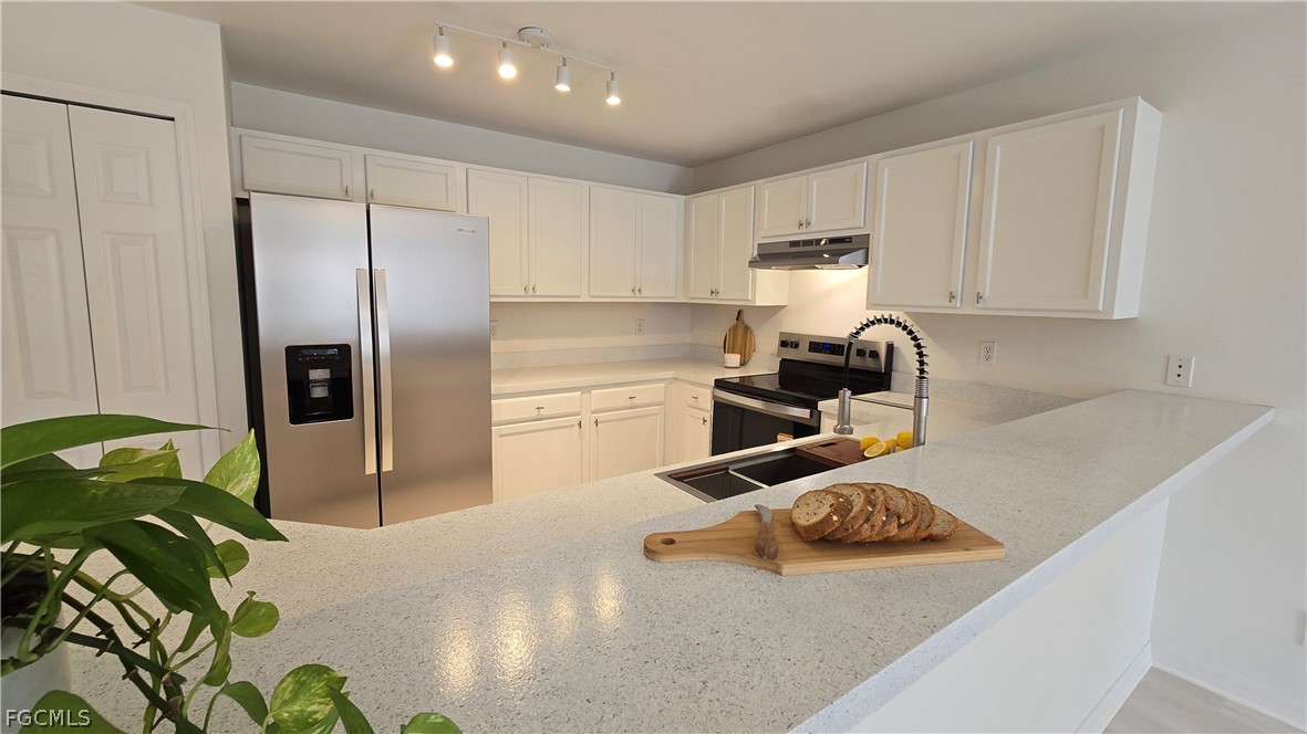 236-238 Peerless Street Lehigh Acres, FL 33974 - Photo 2 of 25 a kitchen with a sink a stove and a refrigerator
