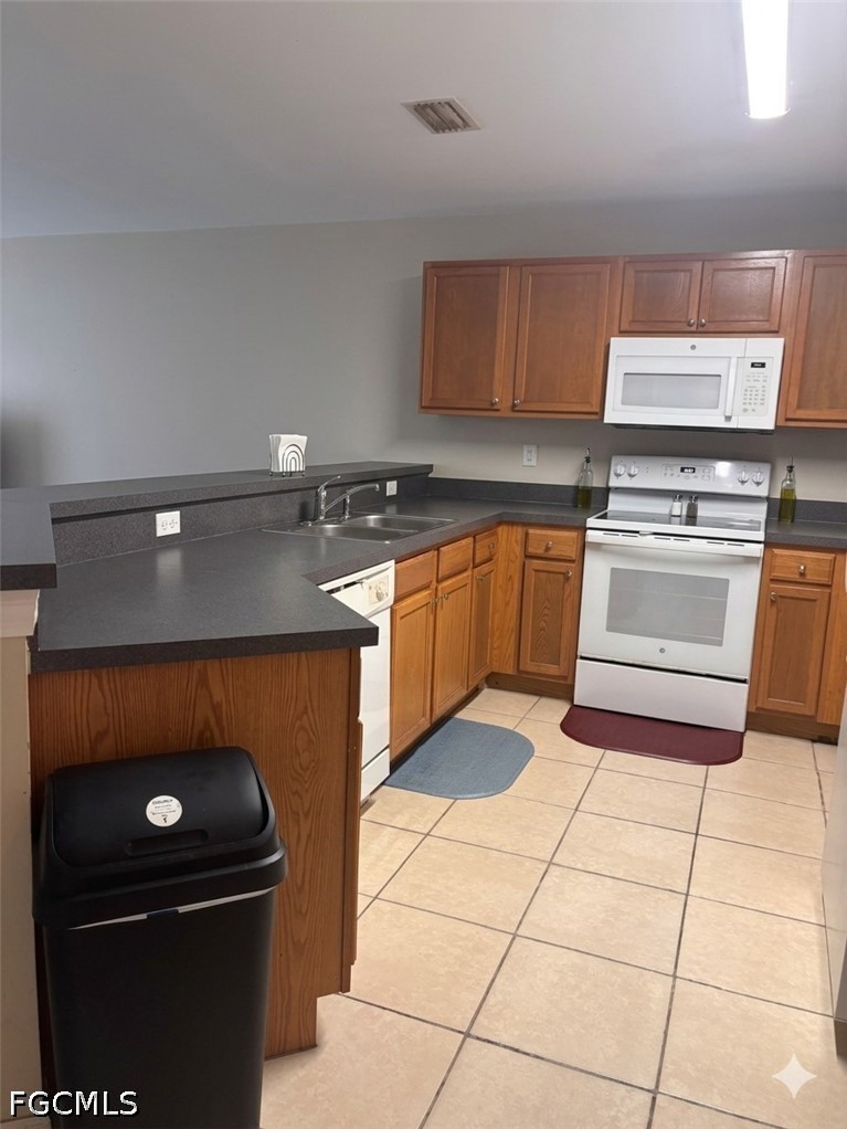 236-238 Peerless Street Lehigh Acres, FL 33974 - Photo 21 of 25 a kitchen with granite countertop a stove top oven and cabinets