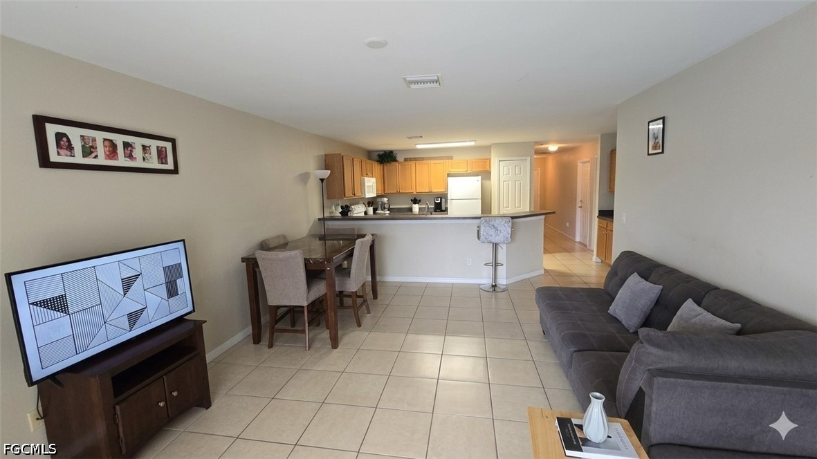 236-238 Peerless Street Lehigh Acres, FL 33974 - Photo 22 of 25 a living room with furniture and a flat screen tv