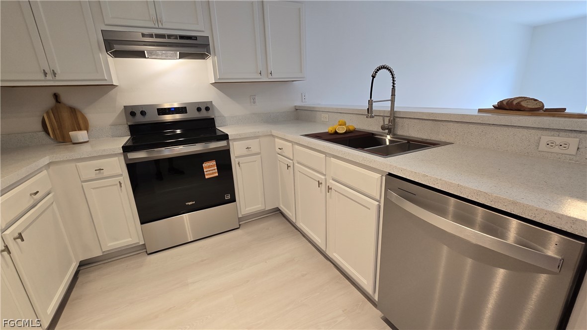 236-238 Peerless Street Lehigh Acres, FL 33974 - Photo 3 of 25 a kitchen with a sink and cabinets