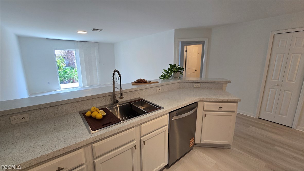236-238 Peerless Street Lehigh Acres, FL 33974 - Photo 5 of 25 a kitchen with a stove cabinets and a wooden floor