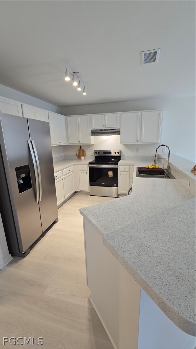 236-238 Peerless Street Lehigh Acres, FL 33974 - Photo 6 of 25 a kitchen with stainless steel appliances a refrigerator a sink a stove a microwave and island