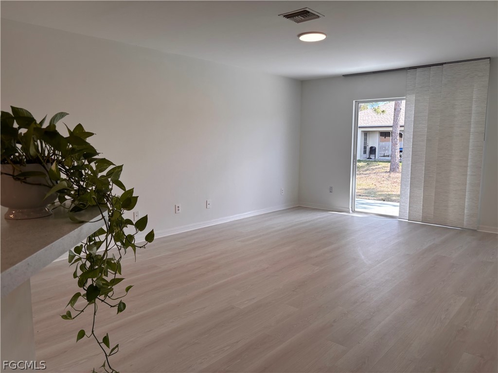 236-238 Peerless Street Lehigh Acres, FL 33974 - Photo 9 of 25 a view of a room with wooden floor and potted plant