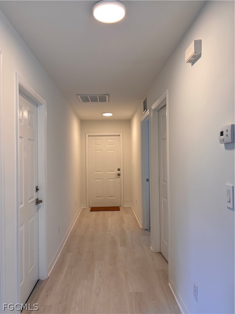 236-238 Peerless Street Lehigh Acres, FL 33974 - Photo 10 of 25 a view of a hallway with wooden shelves