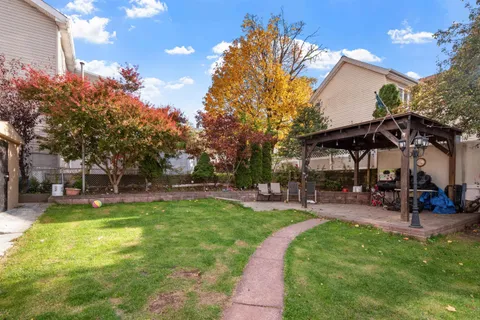a view of a house with a yard patio and sitting area