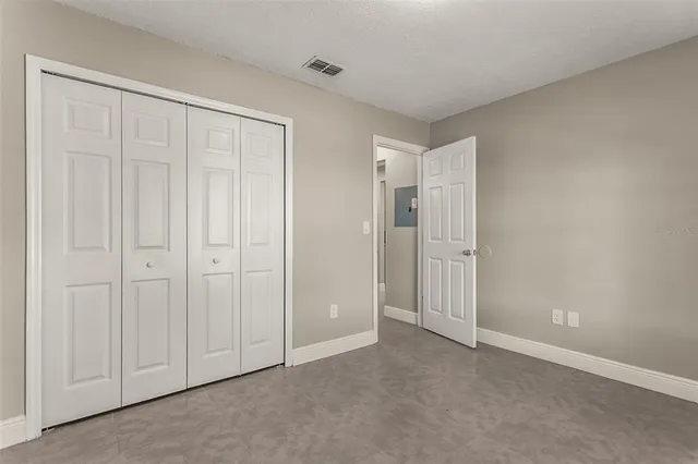 a bathroom with a granite countertop sink toilet a mirror and shower