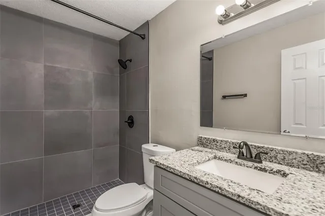 a view of an empty room with wooden floor and a floor to ceiling window