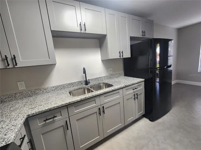 a kitchen with a sink and cabinets