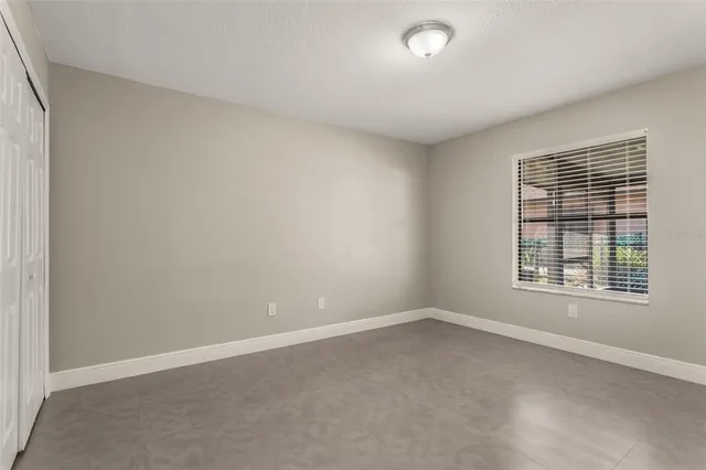 a bathroom with a granite countertop sink toilet and mirror