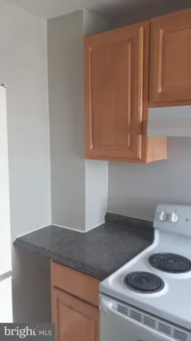 a kitchen with granite countertop cabinets and utility