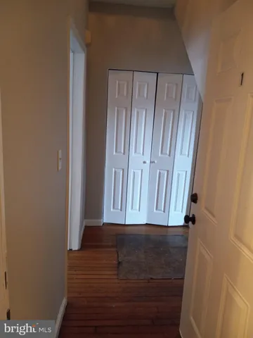 a view of room with wooden floor