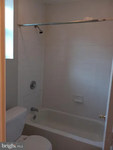 a bathroom with a bathtub and a toilet