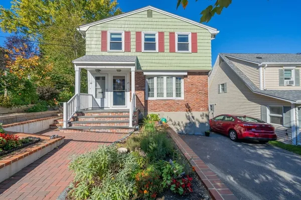 a front view of a house with parking space