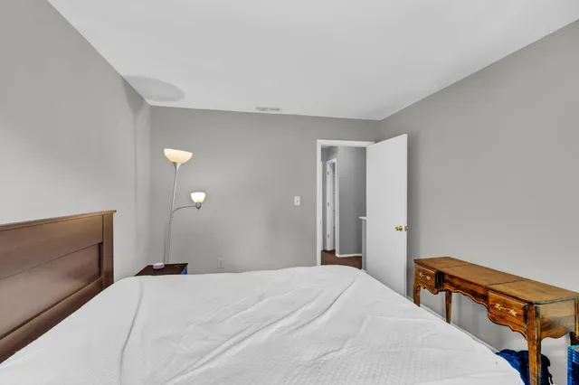 a bedroom with a bed and a dresser