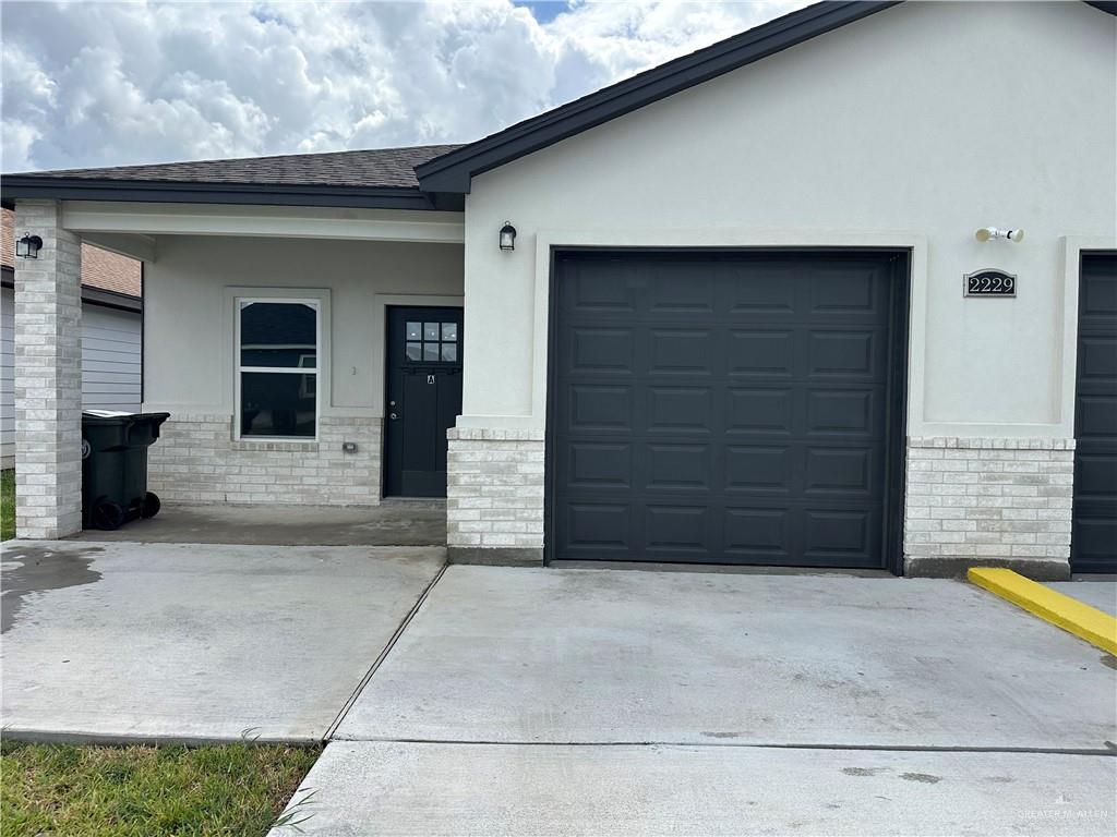 a front view of a house with garage