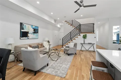 a living room with furniture and wooden floor