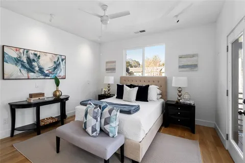 a bedroom with a bed and wooden floor