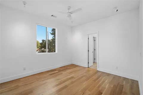 wooden floor in an empty room with a window