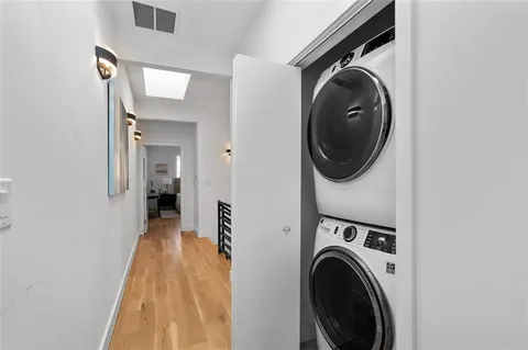 a view of a hallway with washer and dryer