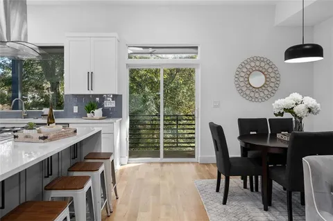 a dining room with furniture a rug and a large window