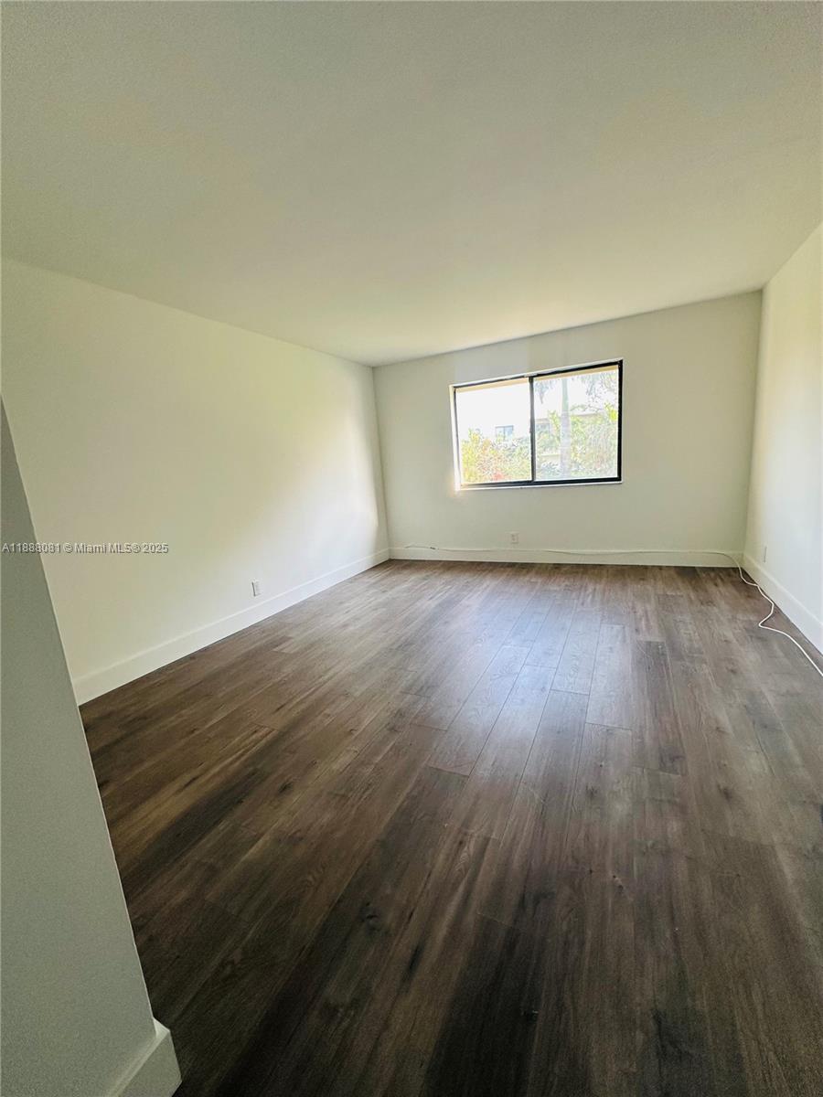 16491 Blatt Boulevard, Unit 202 Weston, FL 33326 - Photo 11 of 21 an empty room with wooden floor and windows