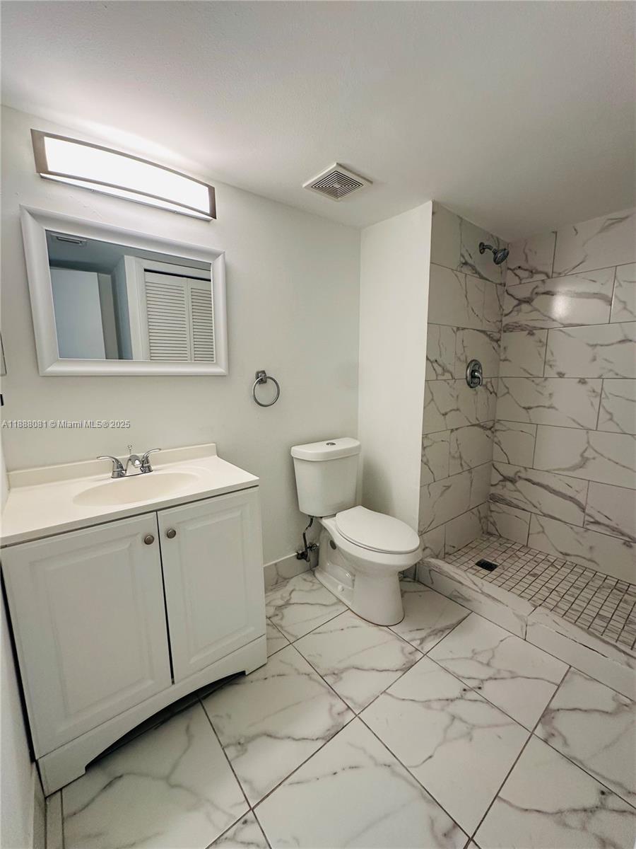 16491 Blatt Boulevard, Unit 202 Weston, FL 33326 - Photo 14 of 21 a bathroom with a toilet sink and a shower