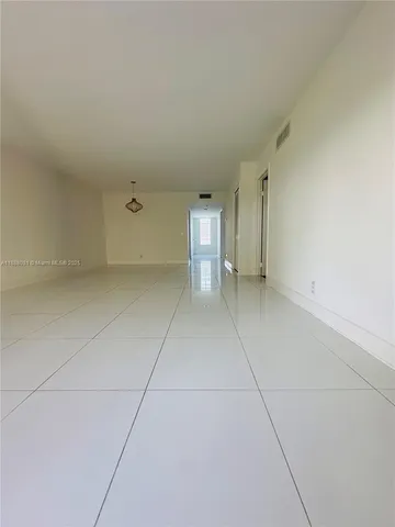 a view of an empty room with a bathroom