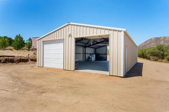 a view of a house with a balcony and car parked