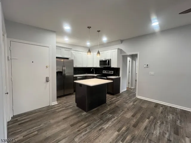 a large kitchen with a refrigerator and a stove top oven