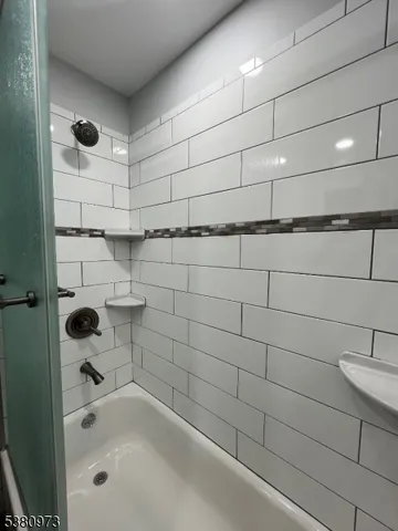 a bathroom with a shower and a bathtub