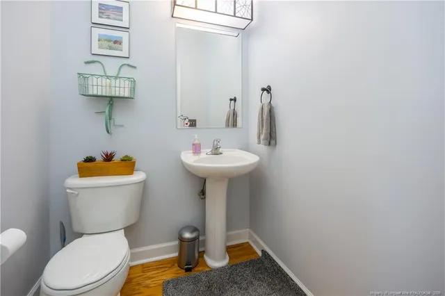 a bathroom with a sink mirror and toilet