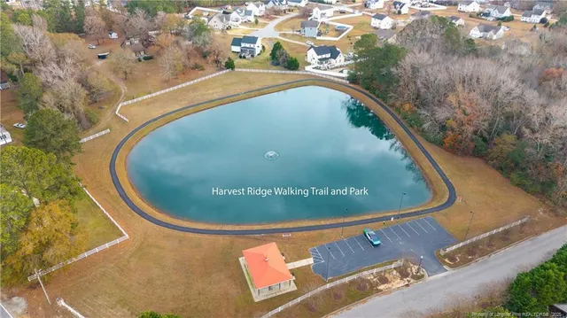 a view of a swimming pool with a yard and mountain view in back