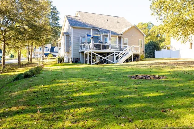 a view of a house with a yard patio and fire pit