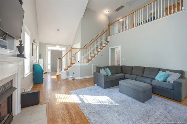 a living room with furniture and stairs