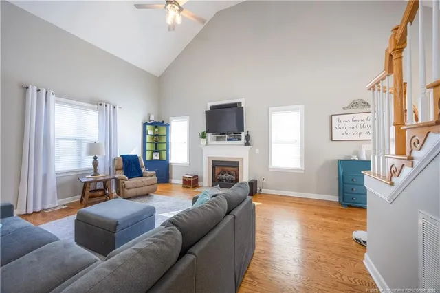 a living room with furniture a fireplace and a large window